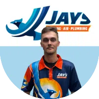 A man wearing a Jays Plumbing, Air, and Plumbing polo shirt stands in front of a Jays company logo, representing their team of 5-Star Technicians.