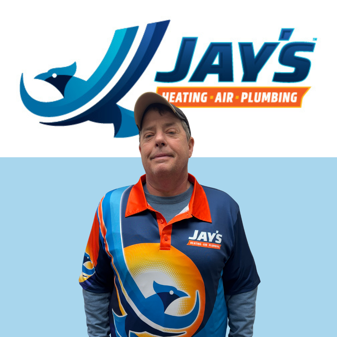 A man in a Jay's Heating, Air, and Plumbing shirt and cap stands in front of the company's logo on a blue and white background.