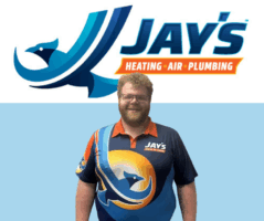 A 5-Star Technician wearing a Jay’s Heating, Air, Plumbing uniform stands in front of a matching company logo and sign.